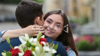 Cheerful young woman embracing man with hands