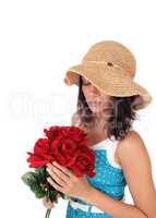 Beautiful woman with bunch of red roses.