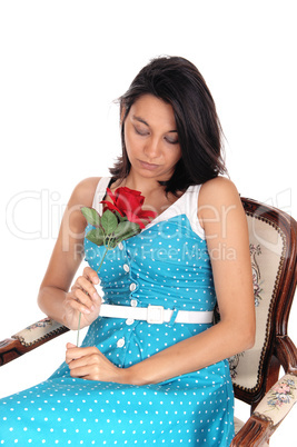 Young woman sitting in armchair.