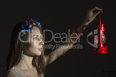 Portrait of a young woman in a wreath of flowers