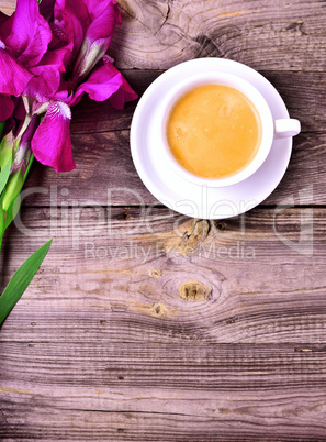 Cup of coffee and lilac iris