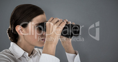 Composite image of close up of confident businesswoman looking through binoculars