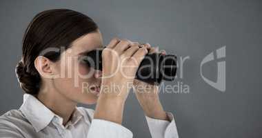 Composite image of close up of confident businesswoman looking through binoculars