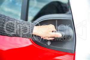 Hand opens car door