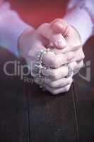 Praying hands of man with rosary