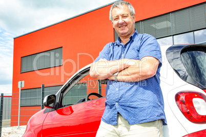Man stands in front of car