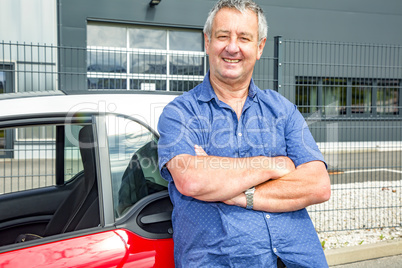 Man stands in front of car