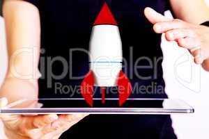 Woman holding tablet pc with rocket