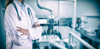 Composite image of asian doctor with arms crossed looking at the camera