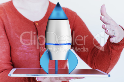 Woman holding tablet pc with rocket