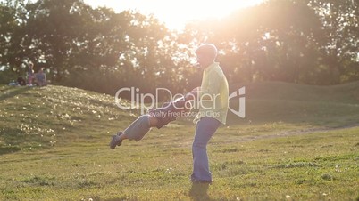 Happy grandmother spinning grandson in circle