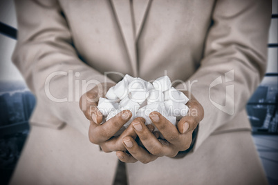 Composite image of womans hands cupped with sugar cubes