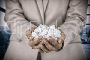 Composite image of womans hands cupped with sugar cubes