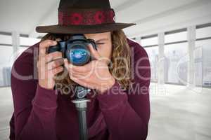 Composite image of male photographer photographing through camera on tripod
