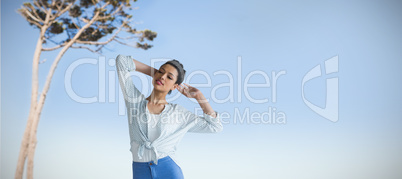 Composite image of beautiful young woman standing