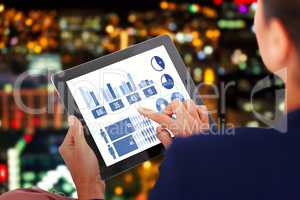 Composite image of businesswoman working on digital tablet over white background
