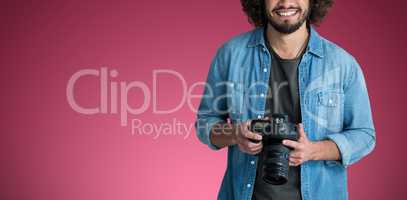 Composite image of portrait of smiling male photographer with camera