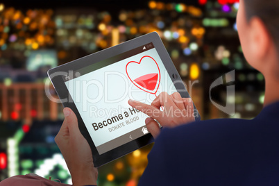 Composite image of businesswoman working on digital tablet over white background