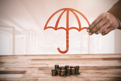 Composite image of hand holding a red umbrella