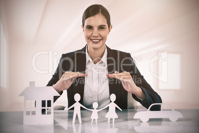 Composite image of family in white paper with a woman in the background