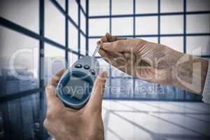 Composite image of close up of man hand testing blood sugar with glucometer