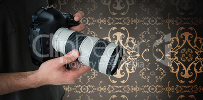 Composite image of mid section of male photographer holding digital camera