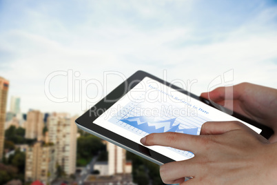 Composite image of close-up of businesswoman holding digital tablet