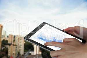 Composite image of close-up of businesswoman holding digital tablet