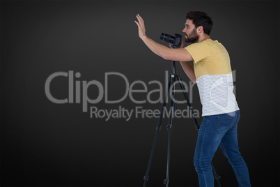 Composite image of full length photographer gesturing while photographing through camera