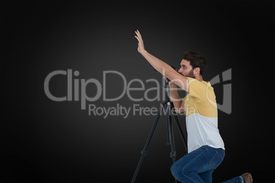 Composite image of side view of photographer gesturing while photographing through camera