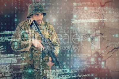 Composite image of soldier holding rifle while standing