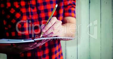 Composite image of hipster taking notes on notebooks