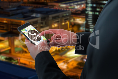 Composite image of businessman using smart phone