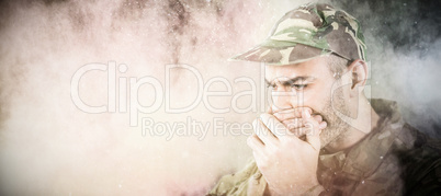 Composite image of soldier covering his mouth