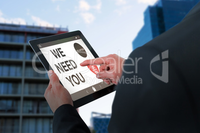 Composite image of businessman touching digital tablet