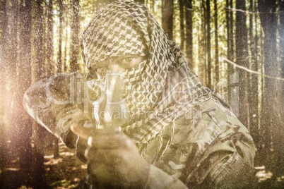 Composite image of portrait of face covered soldier aiming with rifle