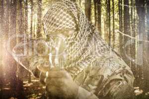 Composite image of portrait of face covered soldier aiming with rifle