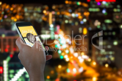 Composite image of close-up of hand holding mobile phone