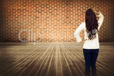 Composite image of full length rear view of brunette with hand in hair