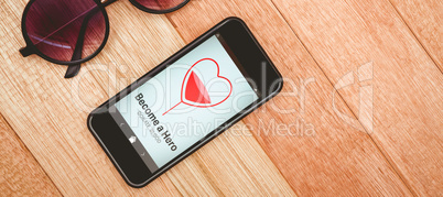 Composite image of become a hero text with heart shape on screen