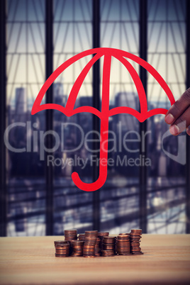 Composite image of hand holding a red umbrella