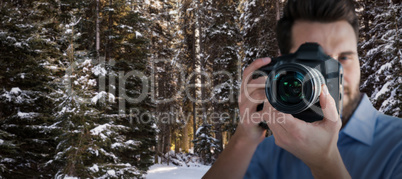 Composite image of male photographer photographing through camera