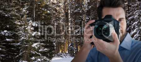 Composite image of male photographer photographing through camera