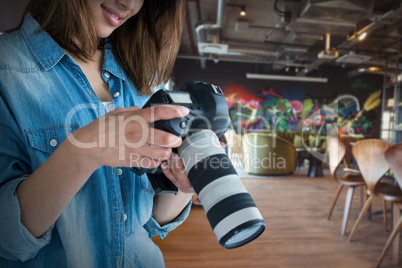Composite image of young female photographer looking at camera