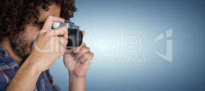 Composite image of male photographer taking picture with camera