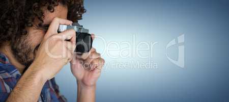 Composite image of male photographer taking picture with camera