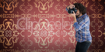 Composite image of male photographer photographing through camera