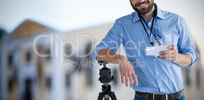 Composite image of portrait of happy man holding identity card