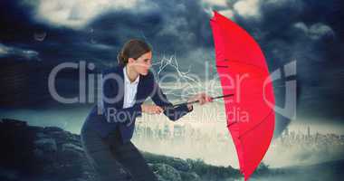 Composite image of businesswoman holding red umbrella