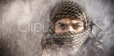 Composite image of portrait of soldier with covered face holding rifle